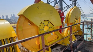 Sparrows technician works on a crown block installation and final inspection on a drill rig derrick at a UAE shipyard.